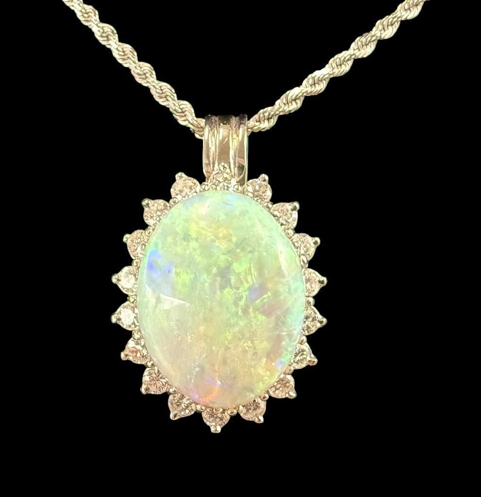 14k White Gold and Opal Pendant with Diamonds: 14k White Gold and 3 ct. Opal Pendant with Diamonds on 14k gold chain. Approx. 8.2 grams. Clasp to pendant approx. 8.75 inches.