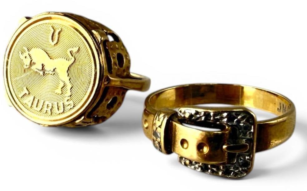 2 14k Gold Rings: 2 14k Gold Rings. Approx. 5.3 grams. Taurus ring approx. size 3. Buckle ring approx. size 5.