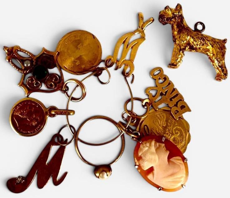 14k Gold Charms and more: 14k Gold Charms and more. Approx. 4.2 grams. Dog, cameo and pendant with green stone are not gold, not counted in weight.