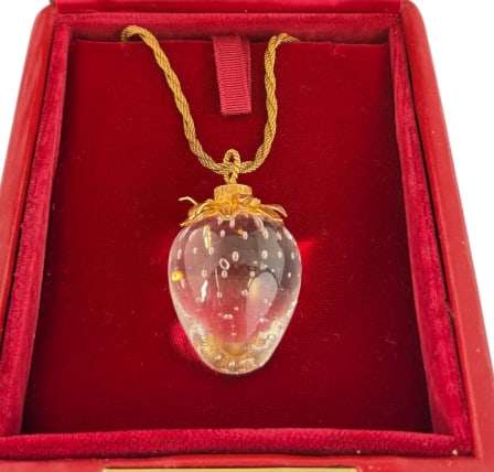 Steuben Glass Strawberry and Gold Necklace: Steuben Glass Strawberry and Gold Necklace. Calyx is marked 18k. Chain is marked 14k. Chain approx. 10.4 grams. Designed by Donald Pollard. Clasp to pendant approx. 11.5 inches.