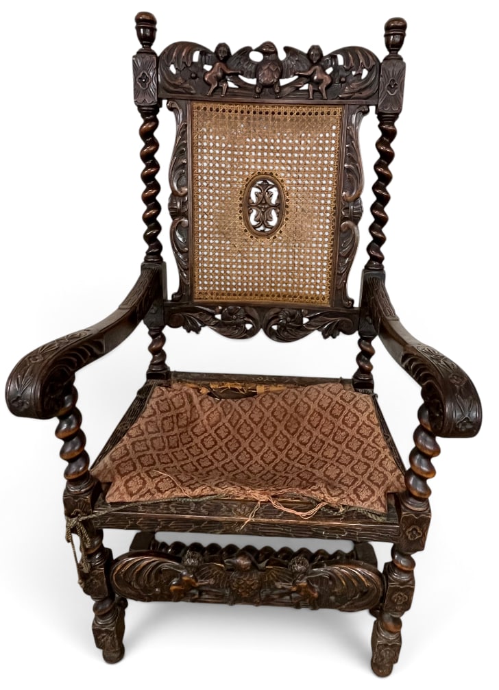 Heavily Carved Oak Jacobean Armchair: Heavily Carved Oak Jacobean style Armchair. Featuring cherubs, birds and flowers. Approx. 48 x 25 x 25 inches.