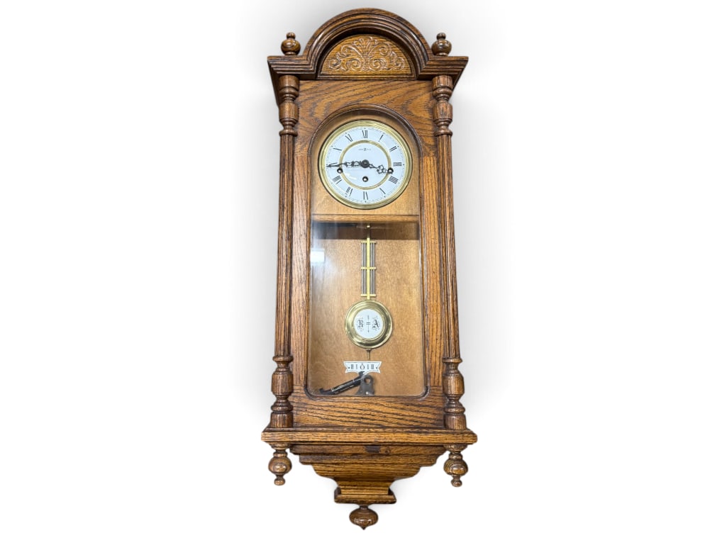 Howard Miller Oak wall clock: Howard Miller Oak wall clock. Approx. 32 x 12 x 7 inches.
