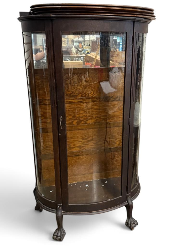 Oak Curved Glass China Cabinet: Oak Curved Glass China Cabinet. Includes 4 shelves. Approx. 63 x 34.5 x 16 inches.