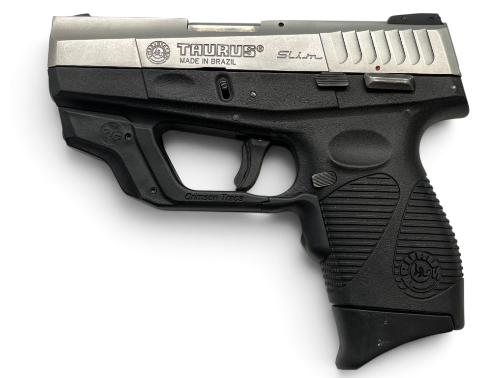 Taurus PT709 Slim 9mm pistol: Taurus PT709 Slim 9mm semi auto pistol, with Crimson Trace laser. Serial # TGR77167.