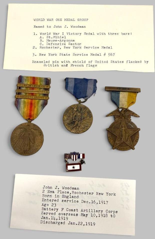WW1 Medal Group: WW1 Medal Group named to John J. Woodman. Including Victory Medal with 3 bars, Rochester NY Service Medal and NY State Service medal. 4 pieces.