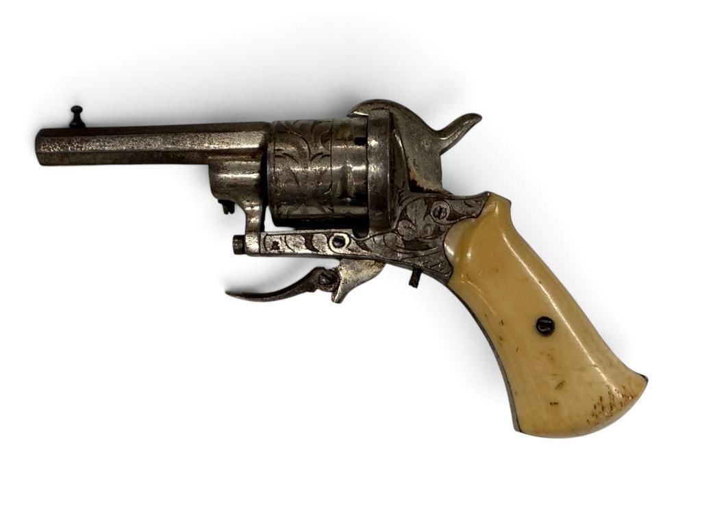 Antique engraved pinfire revolver: Antique engraved pinfire folding trigger revolver with octagon barrel and bone grips. Barrel approx. 2.75 inches.