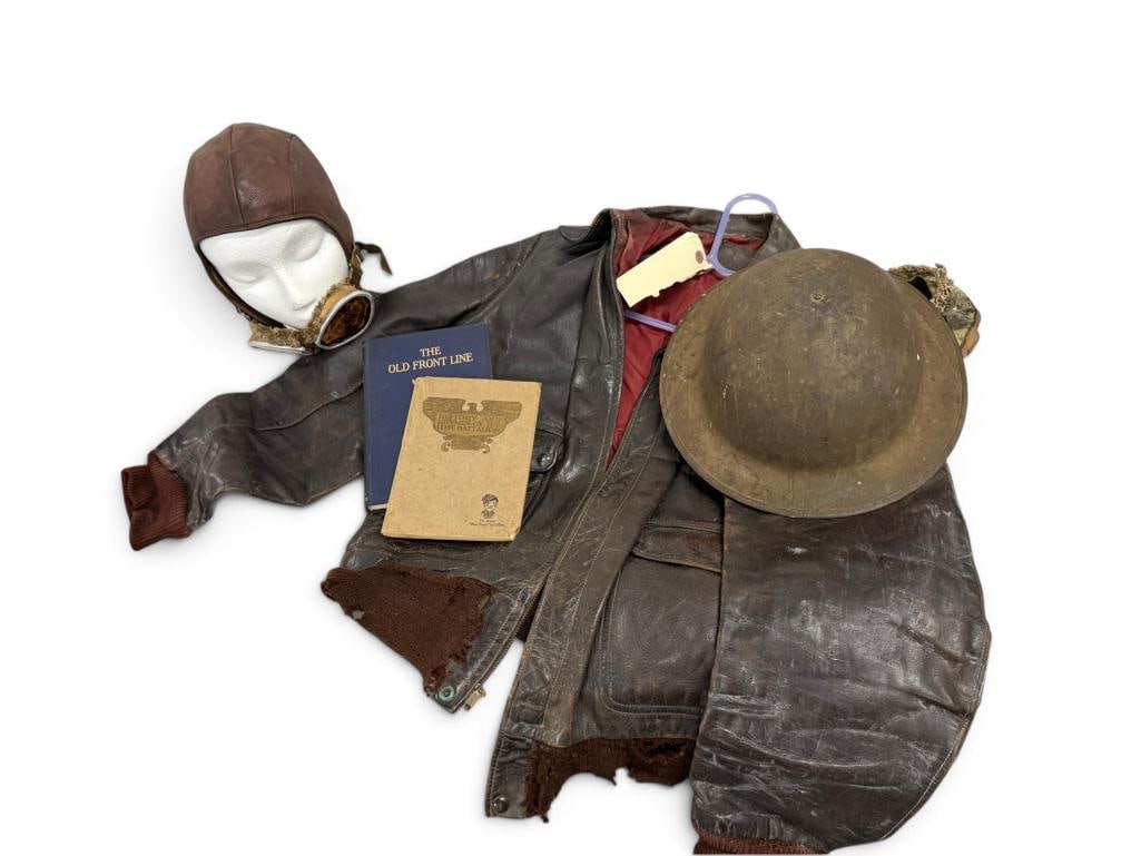 WW2 Bomber jacket, doughboy helmet and books: WW2 Bomber jacket, leather flight helmet, doughboy helmet and books. 5 pieces. Books are History and Rhymes of the Lost Battalion and The Old Front Line.