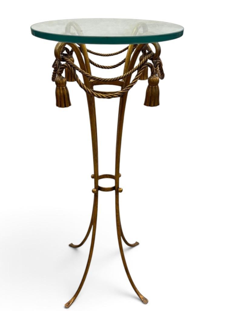 Mid Century Italian gilt metal rope and tassel accent table: Mid Century Italian gilt metal rope and tassel accent table with glass top. Approx. 45 x 18 x 18 inches.