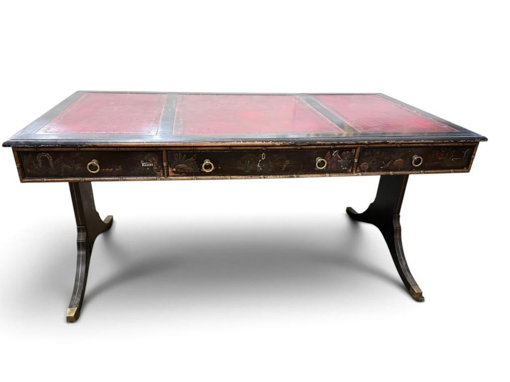 Chinoiserie ebonized writing desk: Chinoiserie ebonized writing desk with red leather top. Approx. 64 x 32 x 32 inches.