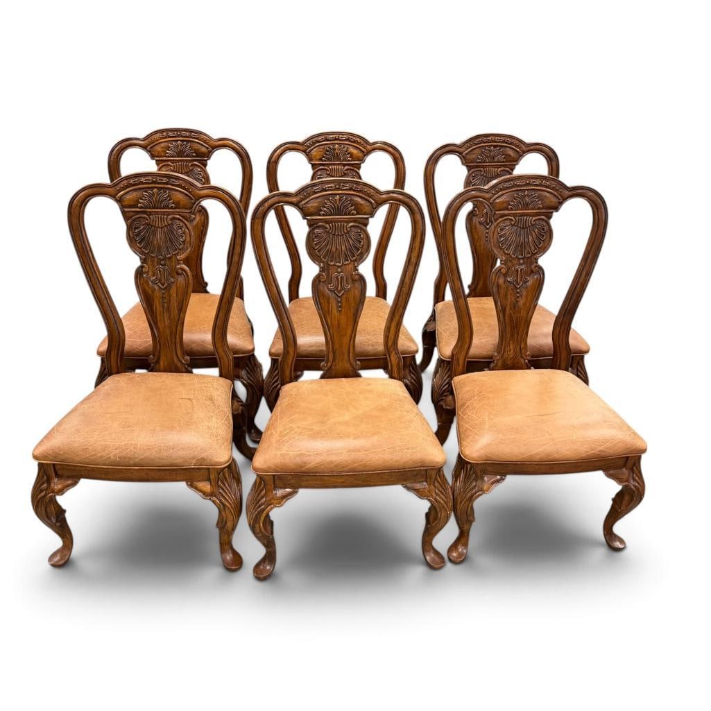 6 Carved wood and leather dining chairs: 6 Carved wood and leather dining chairs. Approx. 44 x 22 x 20 inches.