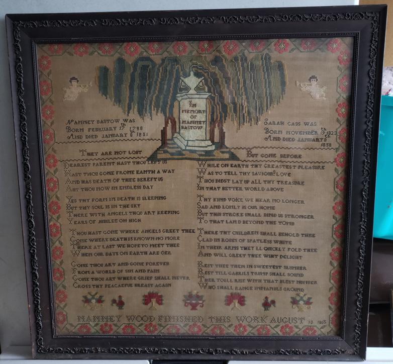 Antique American Needlework Mourning Sampler -1865: Large Antique American Needlework Mourning Sampler -Featuring Trumpeting Angels, Willow Tree and Stone Monument all within a border of flowers - Inscribed " Nanney Wood Finished This Work August 10, 1