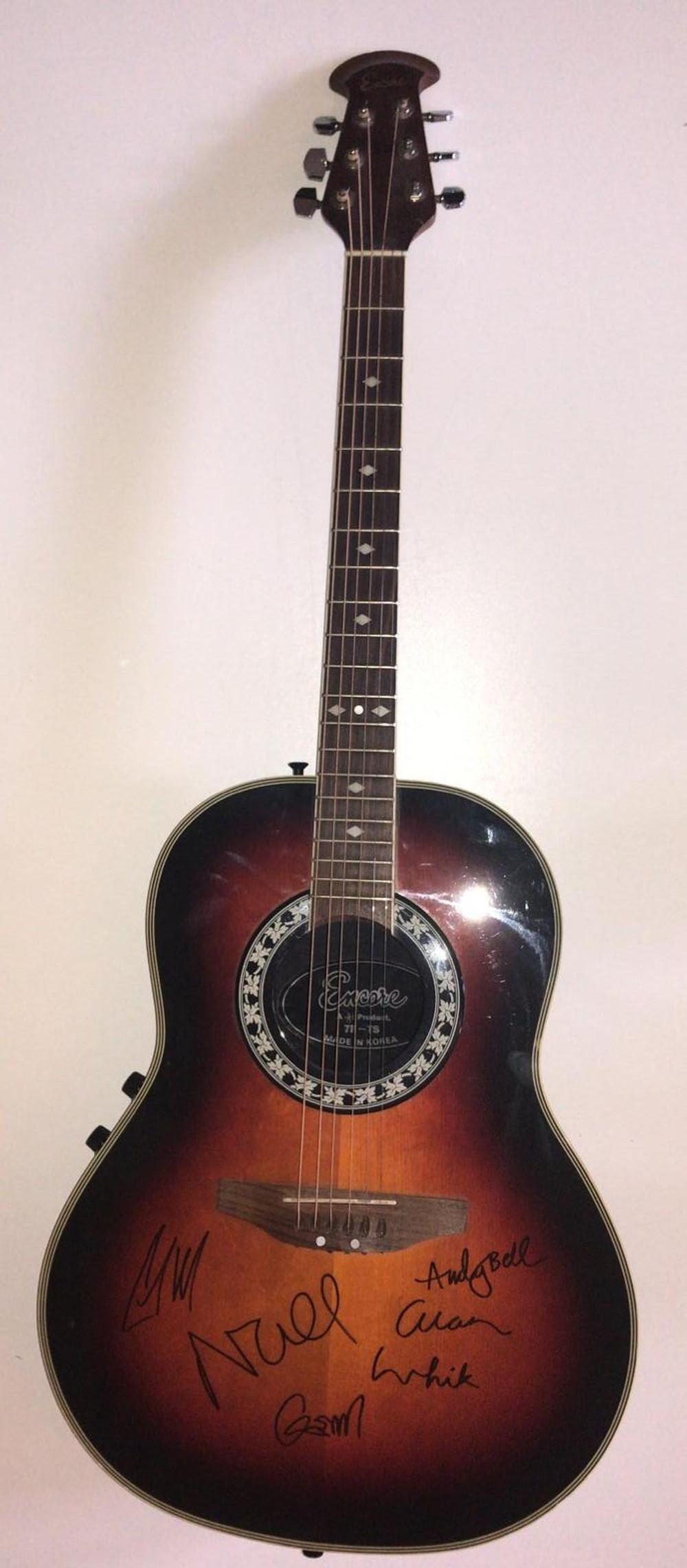 Oasis Fully Signed Vintage Acoustic Guitar Certified: This lot is an acoustic guitar autographed by Noel Gallagher, Liam Gallagher, Gem Archer, Andy Bell and Alan White of Oasis