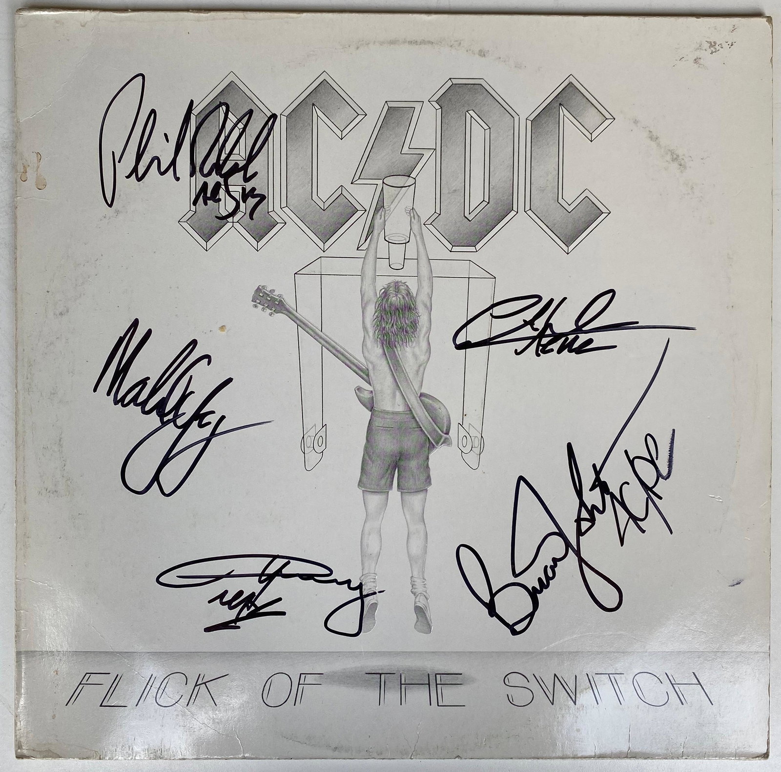 AC/DC Fully Signed Flick Of The Switch Vinyl LP: This lot is a vinyl LP autographed by Brian Johnson, Angus Young, Malcolm Young, Cliff Williams and Phil Rudd of AC/DC