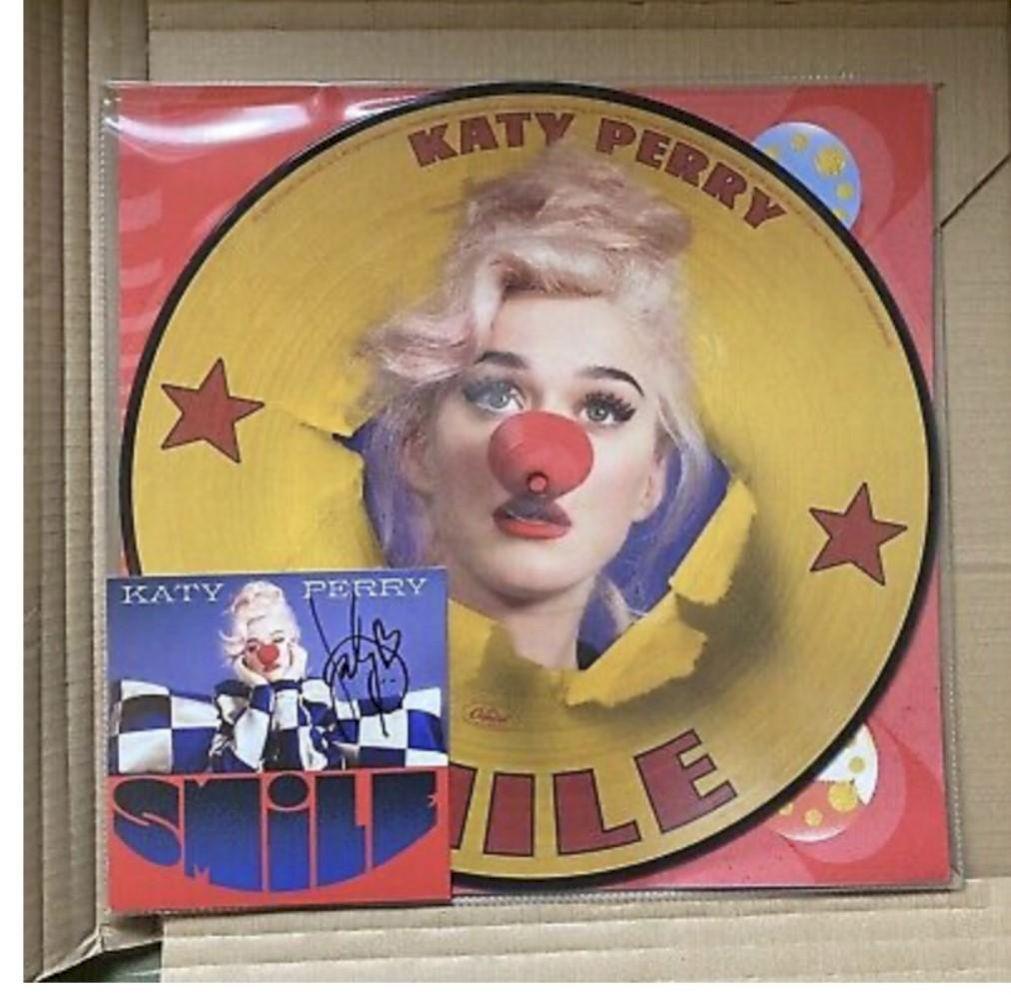 Katy Perry Signed Smile Vinyl Picture Disc Certified: This lot is a vinyl picture disc with official art card, autographed by Katy Perry. Item comes with Certificate of Authenticity guaranteeing it for a lifetime.