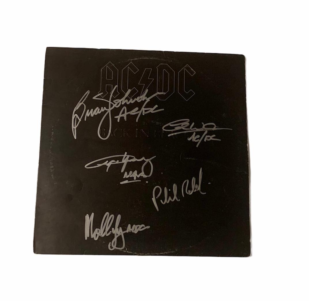 AC/DC Signed Back In Black Vinyl LP Certified: This lot is a vinyl LP autographed by Brian Johnson, Angus Young, Malcolm Young, Cliff Williams and Phil Rudd of AC/DC. Item comes with Certificate of Authenticity guaranteeing it for a lifetime