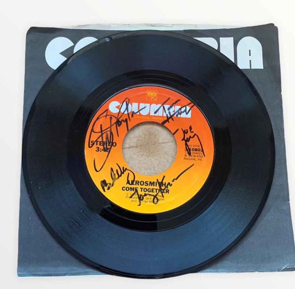 Aerosmith Signed Come Together Vinyl 45 Certified: This lot is a vinyl 45 (Come Together) autographed by Steven Tyler, Joe Perry, Tom Hamilton, Joey Kramer and Brad Whitford of Aerosmith. Item comes with Certificate of Authenticity guaranteeing it for
