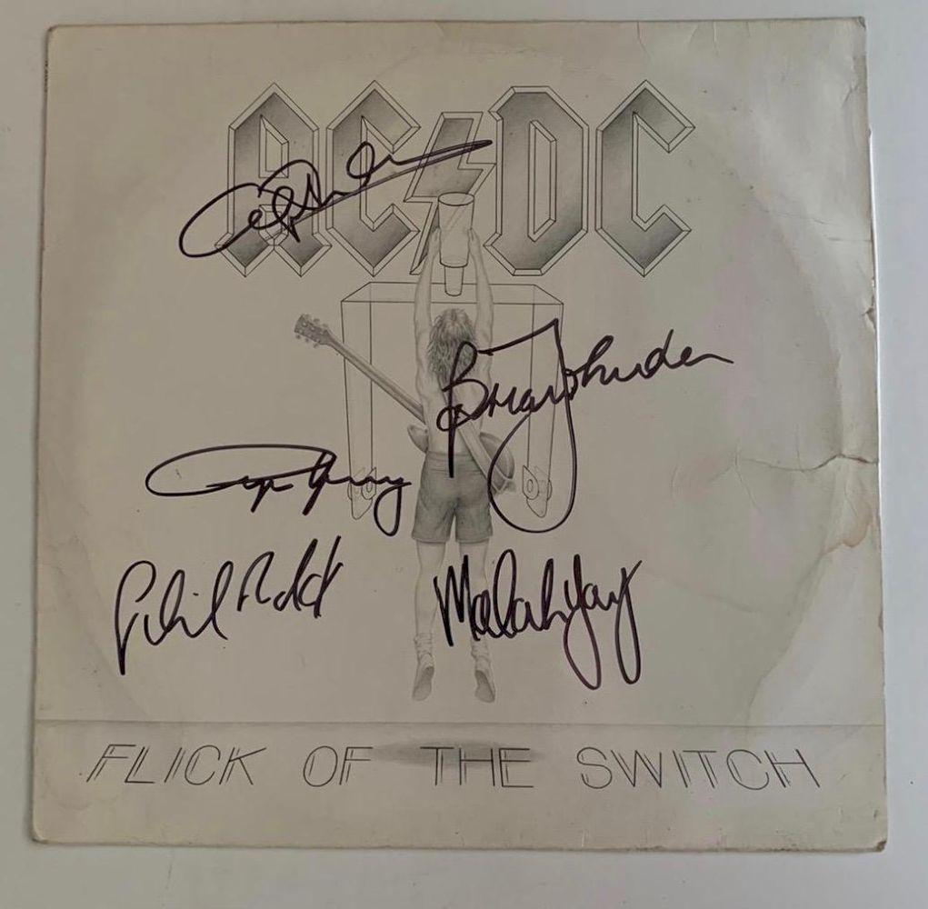AC/DC Flick Of The Switch Signed Vinyl LP Certified: This lot is a vinyl LP autographed by Brian Johnson, Angus Young, Malcolm Young, Cliff Williams and Phil Rudd of AC/DC. Item comes with Certificate of Authenticity guaranteeing it for a lifetime.