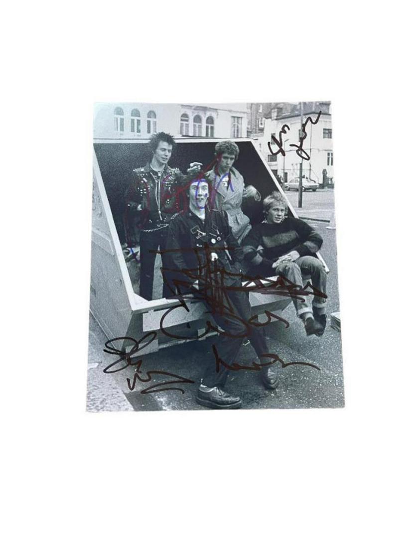 Sex Pistols Signed Photograph Certified: This lot is a 10 x 8” photograph autographed by Johnny Rotten, Paul Cook, Steve Jones and Glen Matlock of the Sex Pistols. Item comes with Certificate of Authenticity guaranteeing it for a lifet