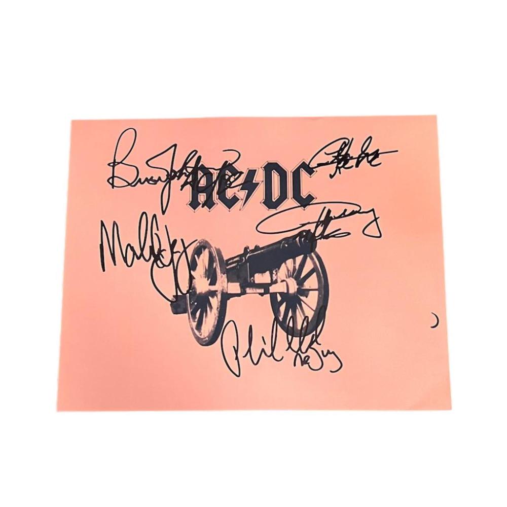 This lot is a framed 10x8" print autographed by Brian Johnson, Angus Young, Malcolm Young, Phil Rudd: This lot is a framed 10x8" print autographed by Brian Johnson, Angus Young, Malcolm Young, Phil Rudd and Cliff Williams of AC/DC. The photo is housed within a mounted black wooden frame, an ideal disp