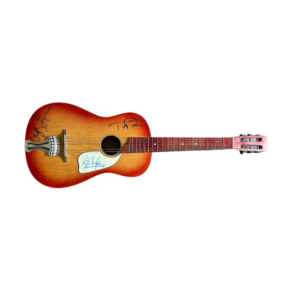 The Traveling Wilburys Signed Vintage Acoustic Guitar: This lot is a vintage 1960's acoustic guitar autographed by Bob Dylan, Tom Petty and Jeff Lynne of The Traveling Wilburys. This item shows some signs of wear as it is a vintage issue guitar. Autograph