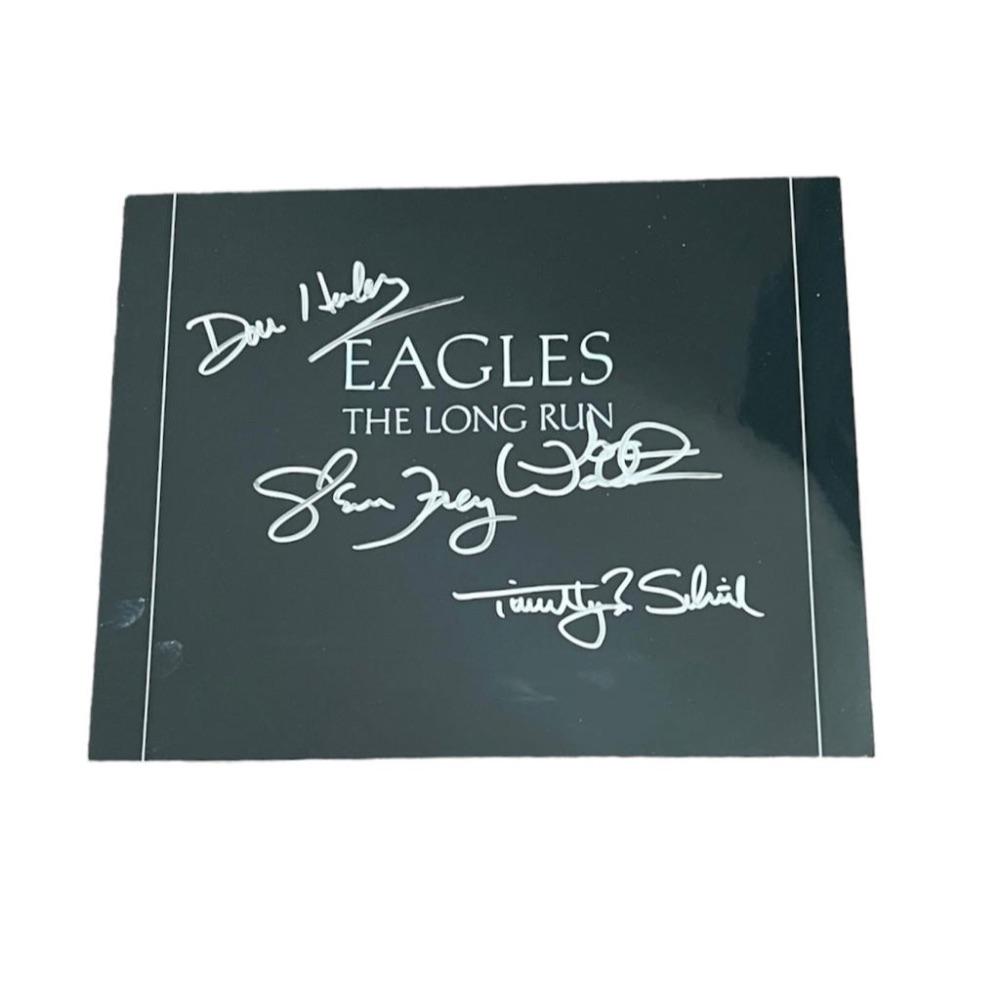 The Eagles Signed Framed Photograph Certified: This lot is a framed 10x8" print autographed by Don Henley, Glenn Frey, Timothy B. Schmit and Joe Walsh of the Eagles.. The photo is housed within a mounted black wooden frame, an ideal display item f