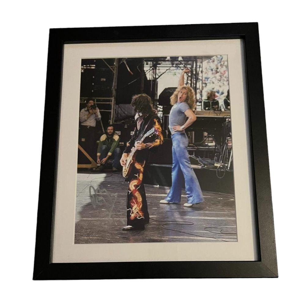 Led Zeppelin Jimmy Page Signed Framed Photograph Certified: This lot is a framed 10x8" print autographed by Jimmy Page of Led Zeppelin. The photo is housed within a mounted black wooden frame, an ideal display item for collectors. Item comes with Certificate o