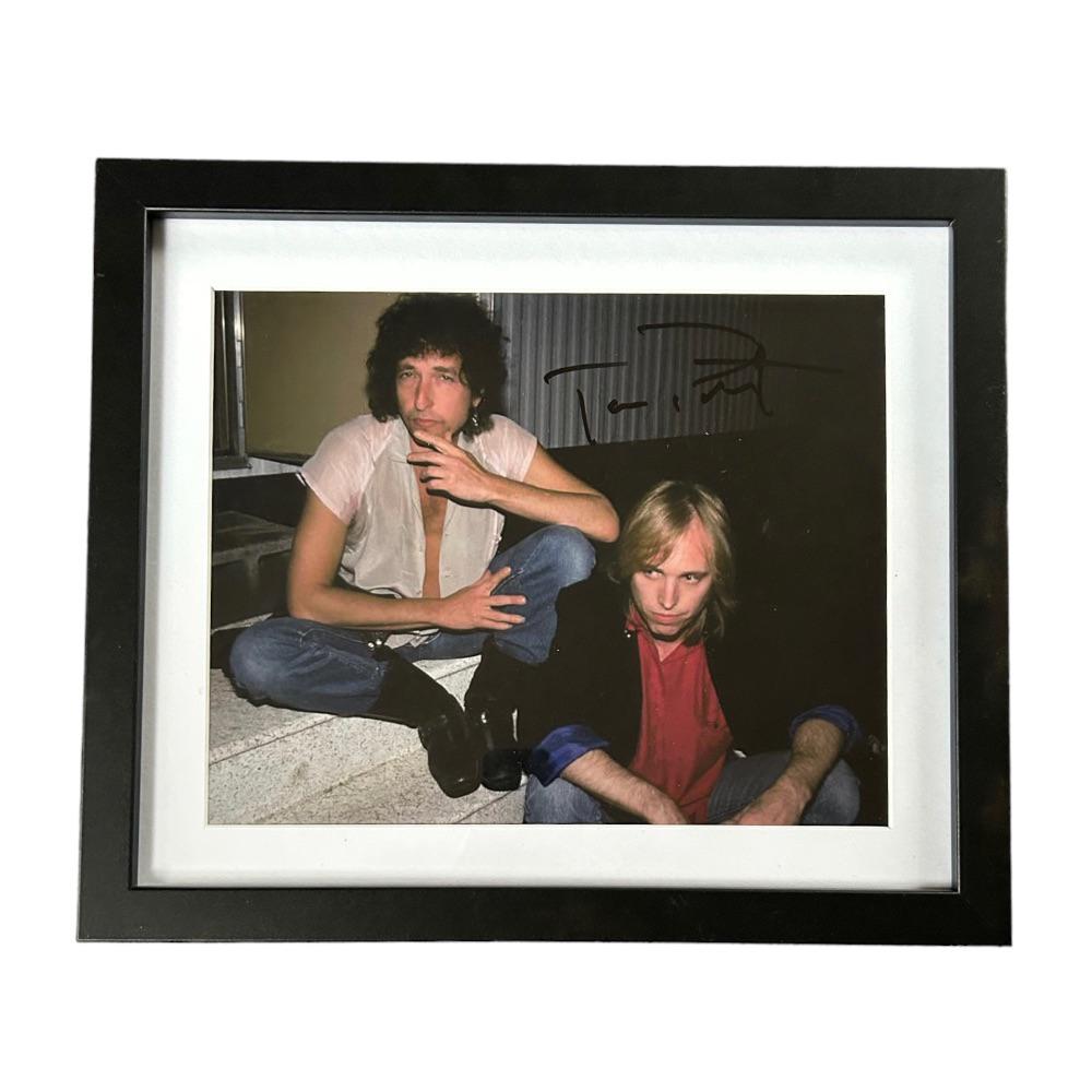 Tom Petty Signed Framed Photograph: This lot is a framed 10x8" print autographed by Tom Petty. The photo is housed within a mounted black wooden frame, an ideal display item for collectors.Thomas Earl Petty (October 20, 1950 â€“ Oc