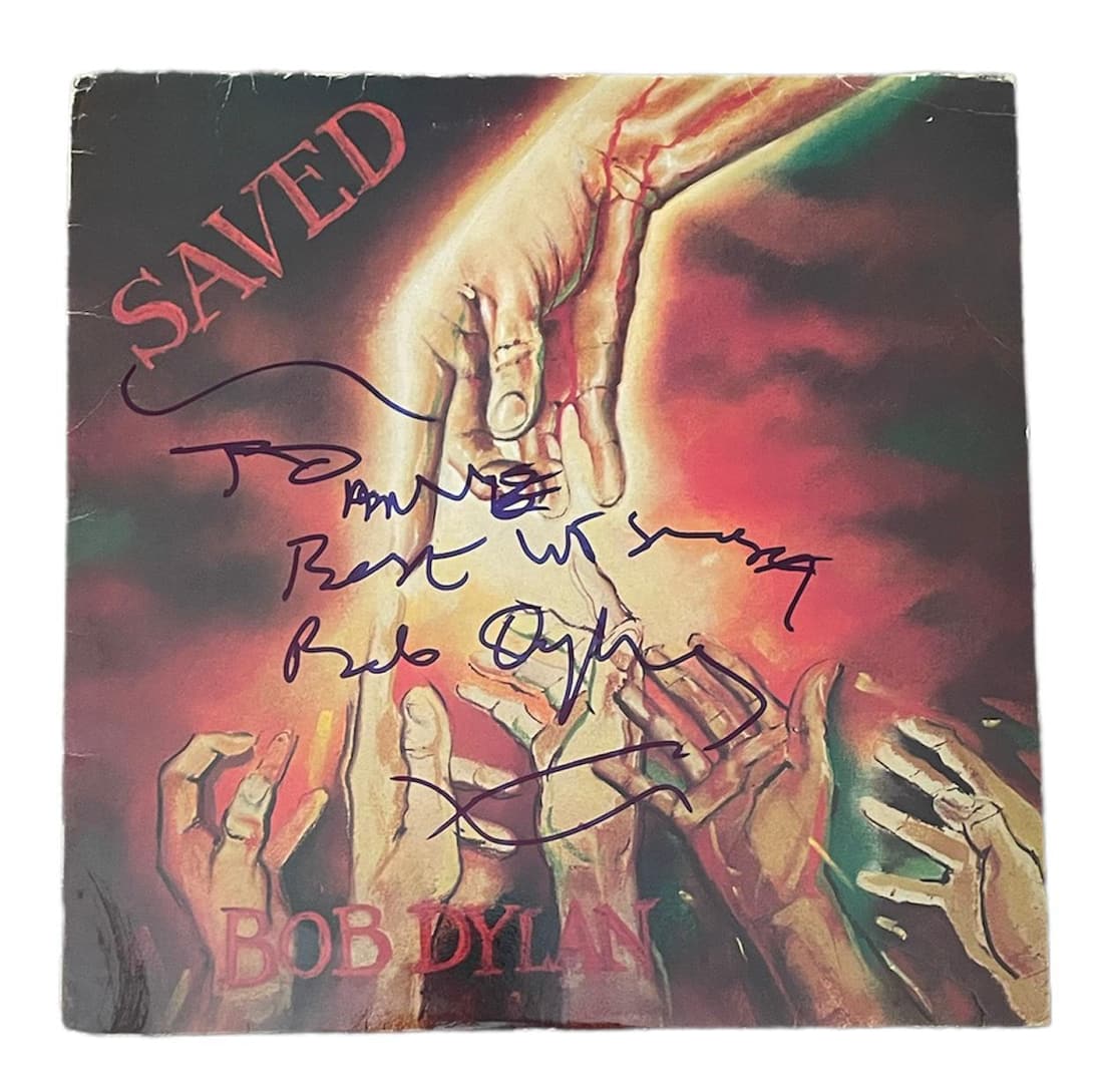 Bob Dylan Signed Saved Vinyl LP Certified: This lot is a Vinyl LP (Saved) autographed by Bob Dylan. Autograph is dedicated " To Anne?"