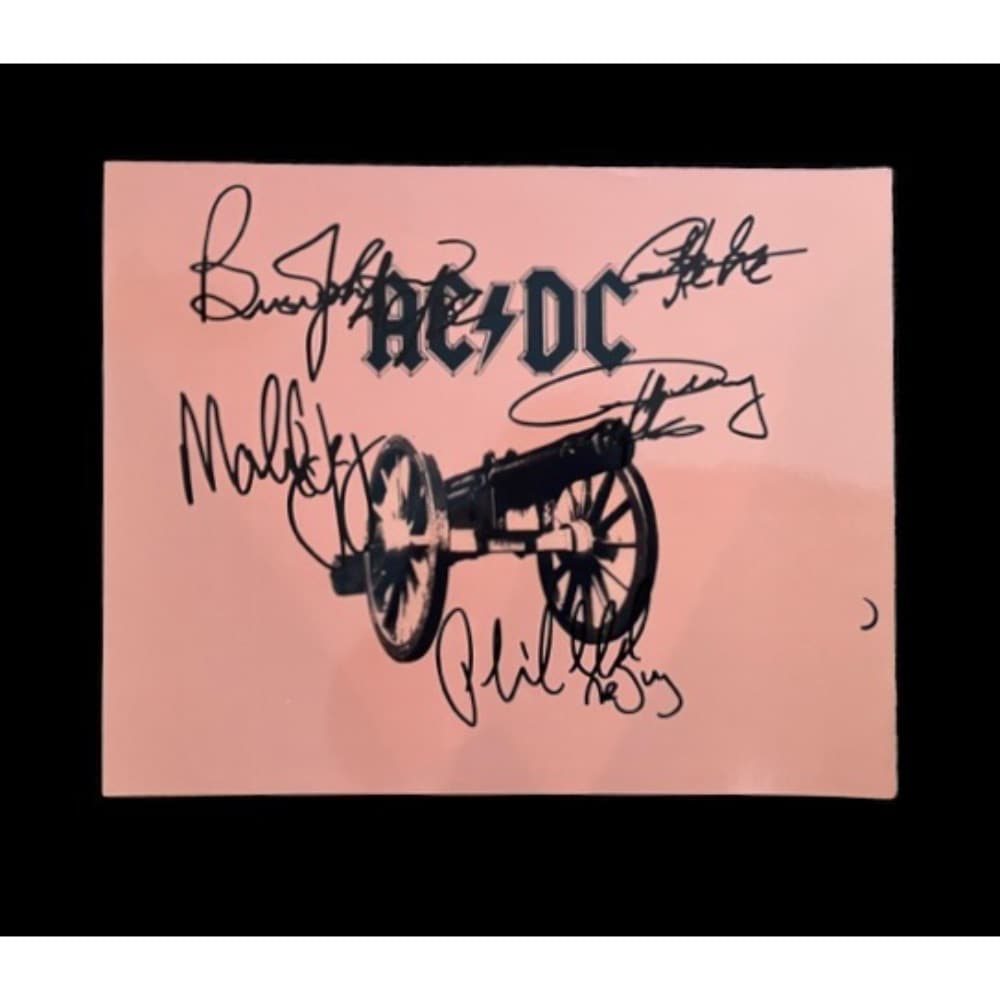 AC/DC Signed Glossy Print: This lot is a 10 x 8" promotional glossy print autographed by Brian Johnson, Angus Young, Malcolm Young, Cliff Williams and Phil Rudd of AC/DC. AC/DC are an Australian rock band formed in Sydney in 19