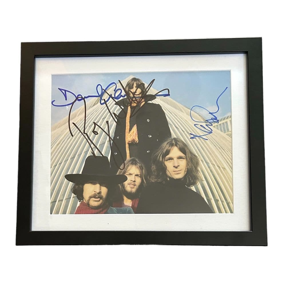 Pink Floyd Signed Framed Photograph: This lot is a framed 10x8" print autographed by Roger Waters, Nick Mason and David Gilmour of Pink Floyd. Pink Floyd are an English rock band formed in London in 1965. Gaining an early following as on