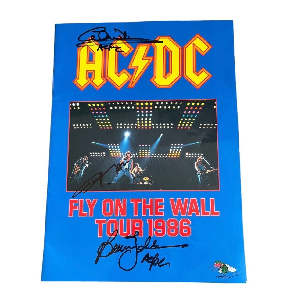 AC/DC Signed Fly On The Wall 1986 Tour Programme Certified: This lot is a tour programme from the 'Fly On The Wall' tour 1986, autogarphed by Brain Johnson, Angus Young and Cliff Williams of AC/DC. AC/DC are an Australian rock band, they have sold more than 20