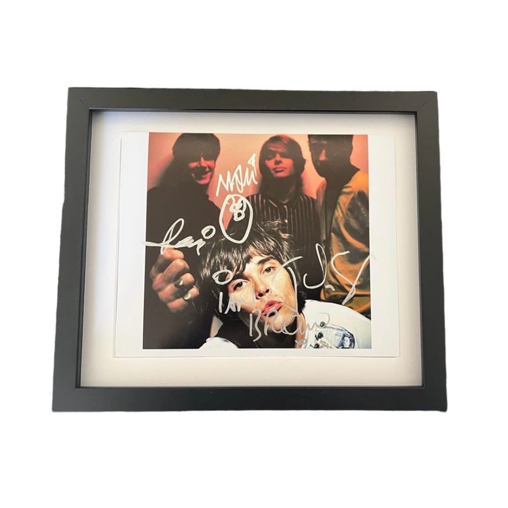 The Stone Roses Fully Signed Framed Photograph: This lot is a framed 10 x 8" photograph autographed in silver sharpie pen by Ian Brown, John Squire, Remi and Mani of Stone Roses. The Stone Roses (affectionately known as The Roses) were an English r