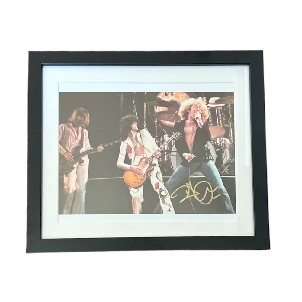 Led Zeppelin Robert Plant Signed Photograph: This lot is a framed 10x8" print autographed by Robert Plant of Led Zeppelin. The photo is housed within a mounted black wooden frame, an ideal display item for collectors. Led Zeppelin were an Englis