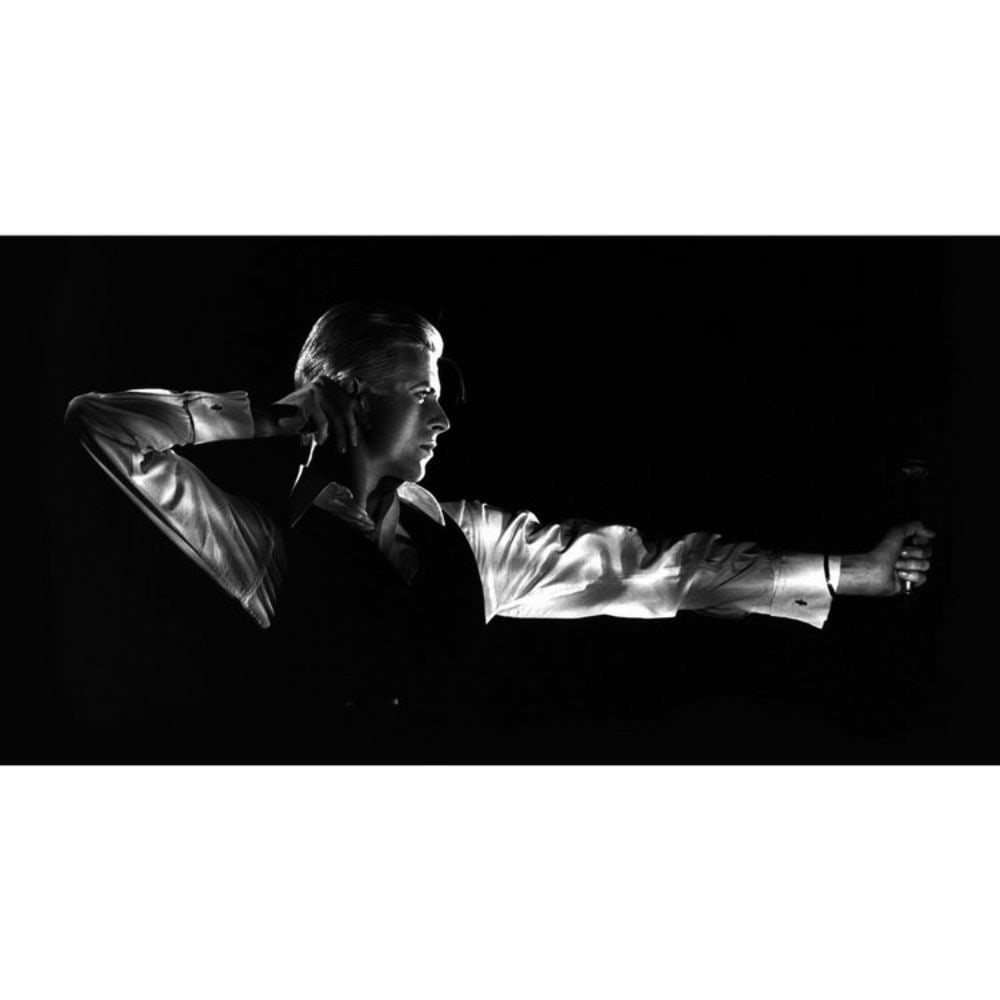 David Bowie Archer February 26th,1976. Open edition Certified: This lot is a 17x22" signed by John Rowlands image. This iconic image of David Bowie as The Thin White Duke was taken by renowned Rock photographer, John Rowlands, on February 26th, 1976, at Maple Lea