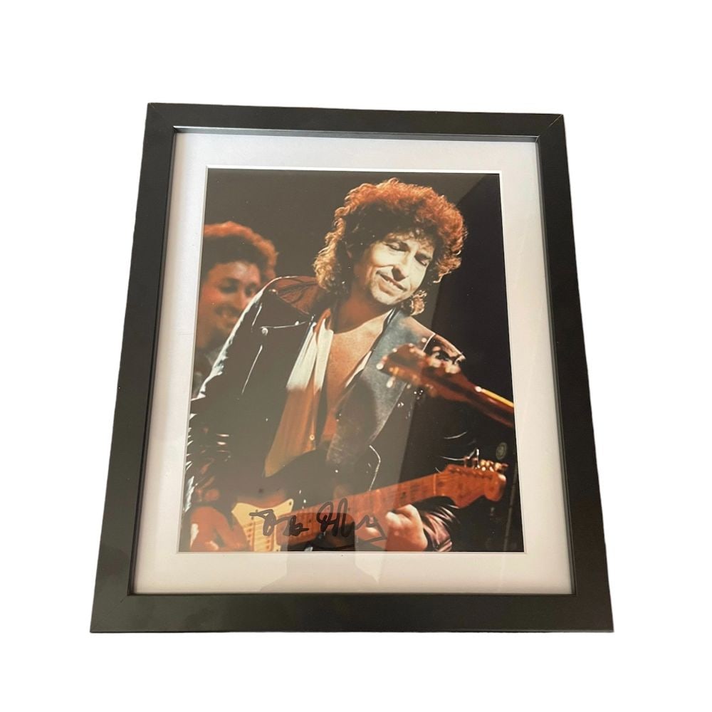Bob Dylan Signed Framed Photograph: This lot is a framed 10x8" print autographed by Bob Dylan. Bob Dylan (legally Robert Dylan, born Robert Allen Zimmerman, May 24, 1941) is an American singer-songwriter. Often regarded as one of the gr