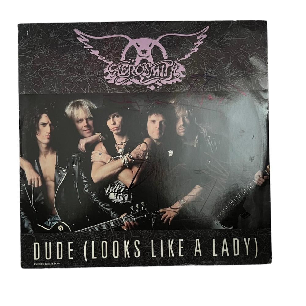 Aerosmith Signed Dude (Looks Like A Lady) 12" Vinyl: This lot is a 12" vinyl (Dude Looks Like A Lady) autographed by Steven Tyler, Joe Perry, Joey Kramer, Tom Hamilton and Brad Whitford of Aerosmith. Item comes with Certificate of Authenticity, guarante
