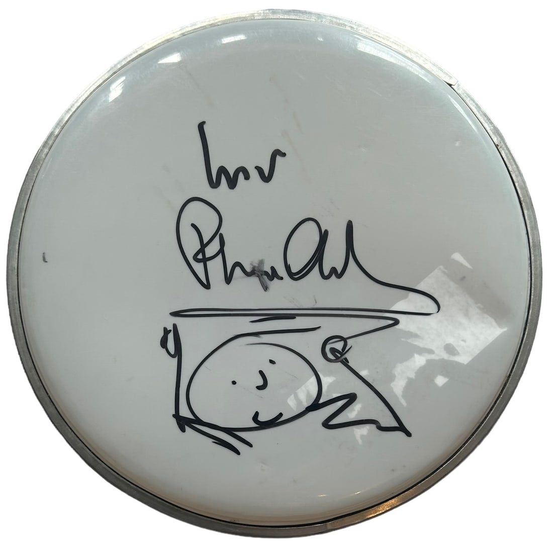 Phil Collins Signed Drumskin: This lot is an 8.5" drumskin, autographed in black sharpie pen by Phil Collins. Item comes with Certificate of Authenticity, guaranteeing it for a lifetime.