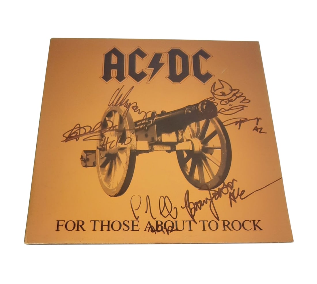 AC/DC Signed Vinyl LP: This lot is a vinyl LP (For Those About To Rock), autographed on the front of the vinyl cover by Brian Johnson, Angus young, Malcolm Young, Cliff Williams and Phil Rudd of AC/DC. Item comes with third