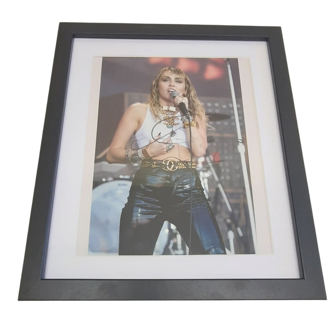 Miley Cyrus Signed Framed Photograph: This lot is a framed 8x10" photograph, autographed by Miley Cyrus. The photo is housed within a mounted black wooden frame, an ideal display item for collectors. Item comes with third-party authentica