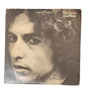 Bob Dylan Signed Vinyl LP: This lot is a vinyl LP (Hard Rain) autographed by Bob Dylan. Item comes with third-party authentication and affixed tamper-proof holographic QR sticker leading to item details and scoring.