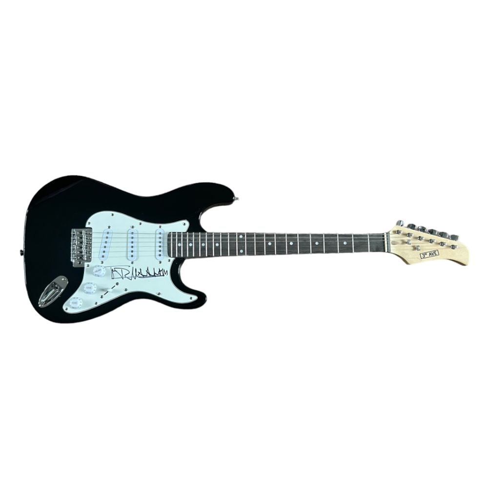 Johnny Rotten The Sex Pistols Signed Electric Guitar: This lot is a black Stratocaster style guitar autographed on the pickguard by Johnny Rotten of The Sex Pistols. The Sex Pistols were an English punk rock band formed in London in 1975. Although their