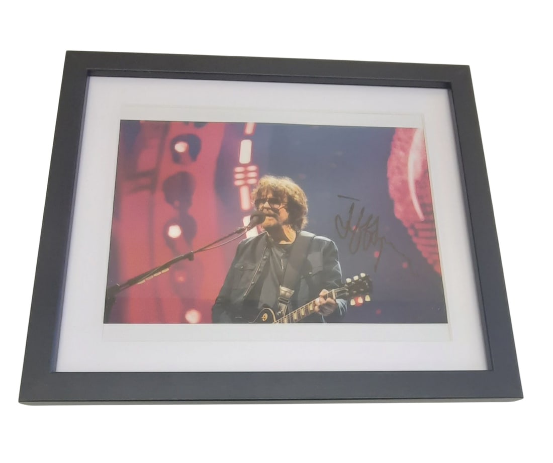 Jeff Lynne ELO Signed Framed Photograph: This lot is a framed 10x8" photograph, autographed by Jeff Lynne of ELO. The photo is housed within a mounted black wooden frame, an ideal display item for collectors. Item comes with third-party auth