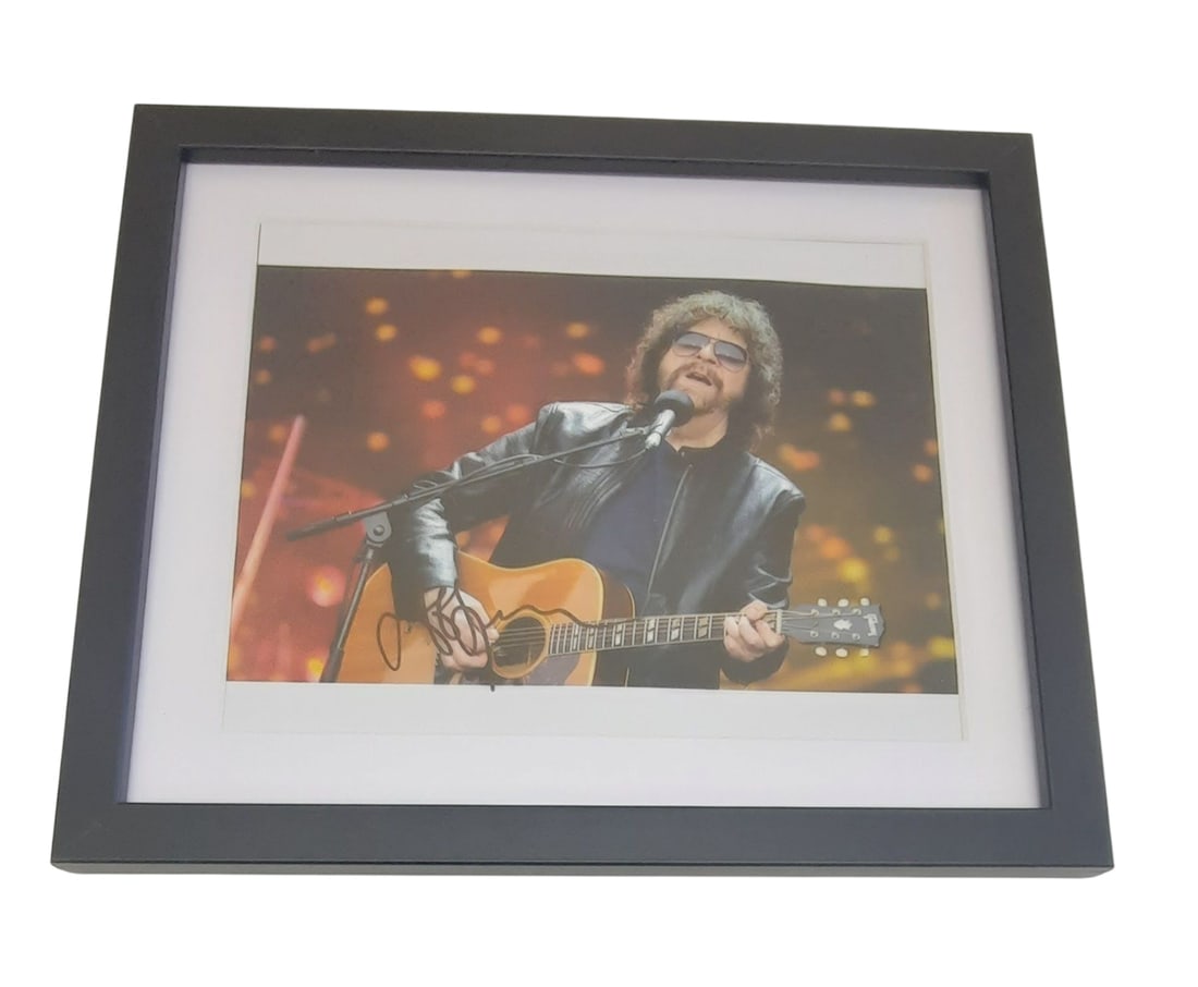 Jeff Lynne ELO Signed Framed Photograph: This lot is a framed 10x8" photograph, autographed by Jeff Lynne of ELO. The photo is housed within a mounted black wooden frame, an ideal display item for collectors. Item comes with third-party auth