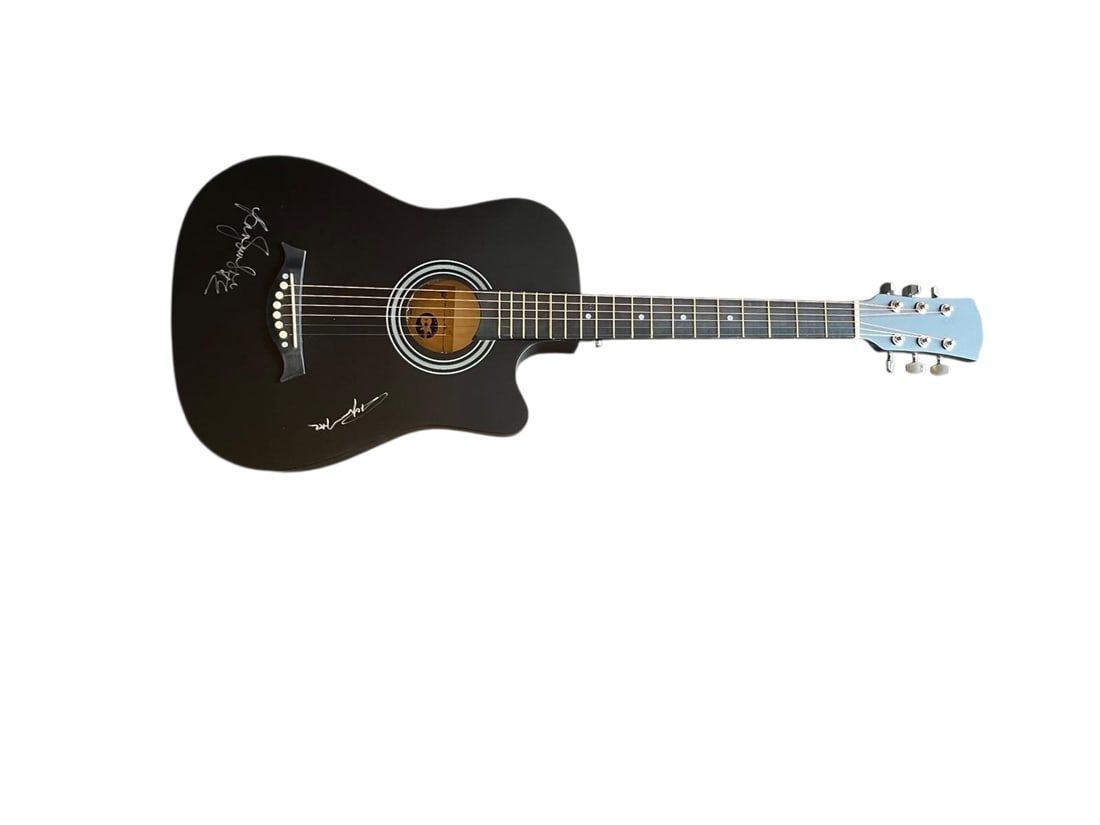AC/DC Signed Acoustic Guitar: This lot is an acoustic guitar, autographed on the body by Brian Johnson and Angus Young of AC/DC. Item comes with third-party authentication and affixed tamper-proof holographic QR sticker leading to