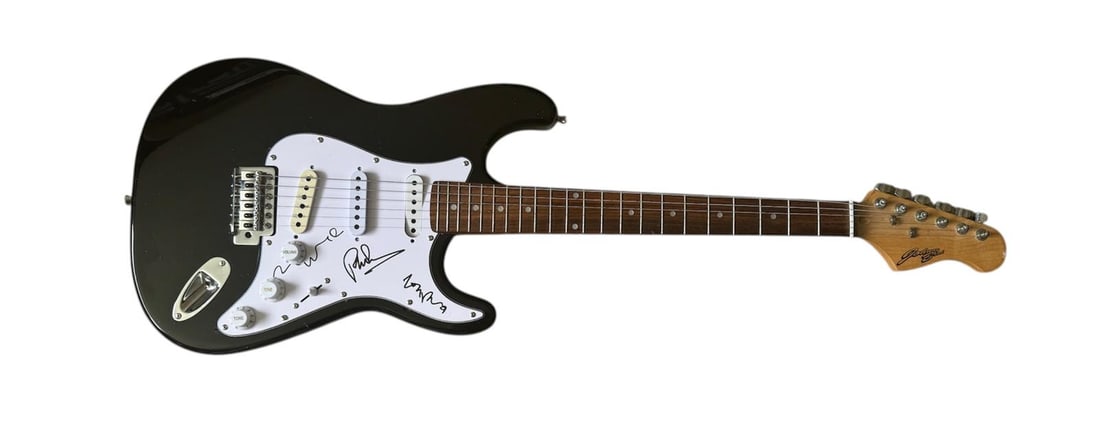 Genesis Signed Electric Guitar: This lot is an electric guitar, autographed on the pickguard by Phil Collins, Tony Banks and Mike Rutherford of Genesis. Item comes with third-party authentication and affixed tamper-proof holographic