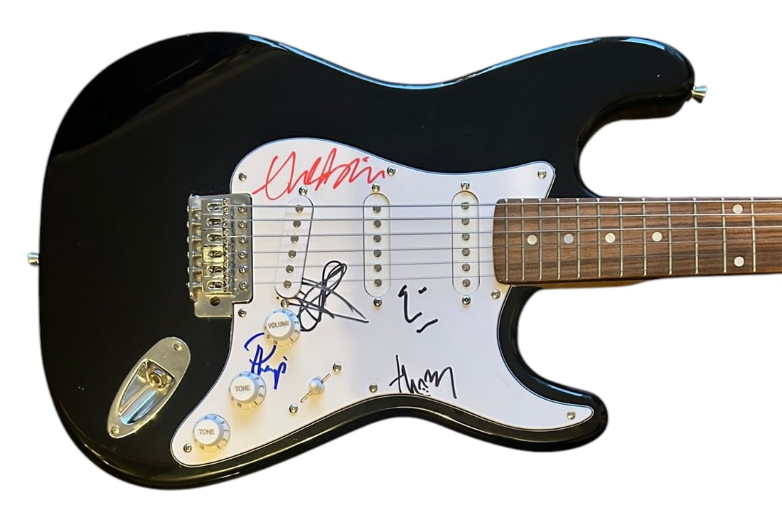 Radiohead Signed Electric Guitar: This lot is an electric guitar, autographed on the pickguard by Thom Yorke, Phil Selway, Colin Greenwood, Jonny Greenwood and Ed O'Brien of Radiohead. Item comes with third-party authentication and af