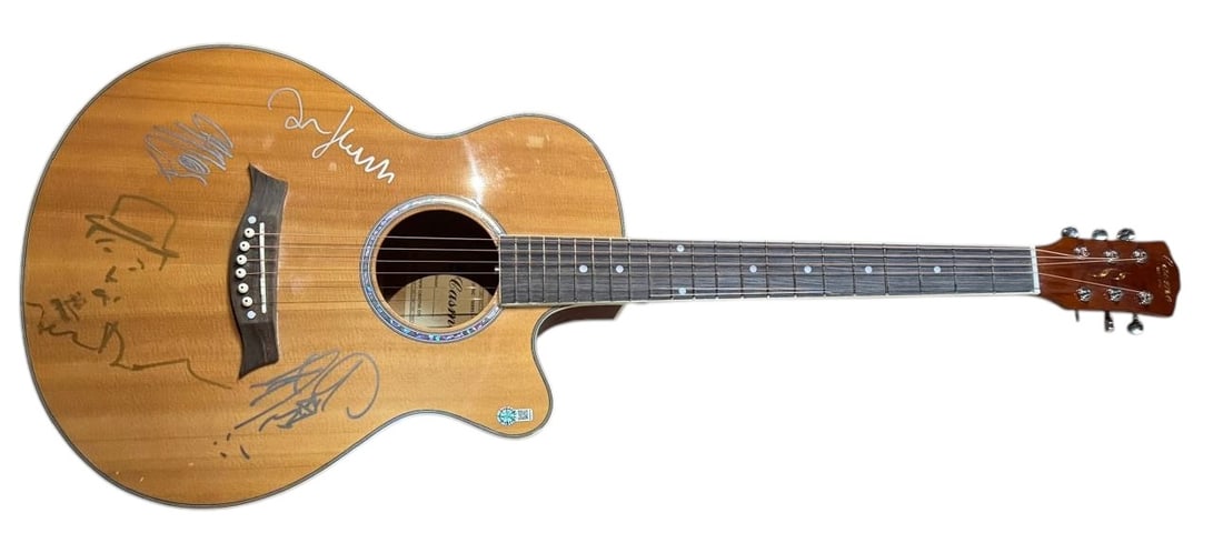 The Libertines Signed Acoustic Guitar: This lot is an acoustic guitar, autographed on the body by Pete Doherty, Carl Barat, John Hassall and Gary Powell of The Libertines. Item comes with third-party authentication from AFTAL and affixed t