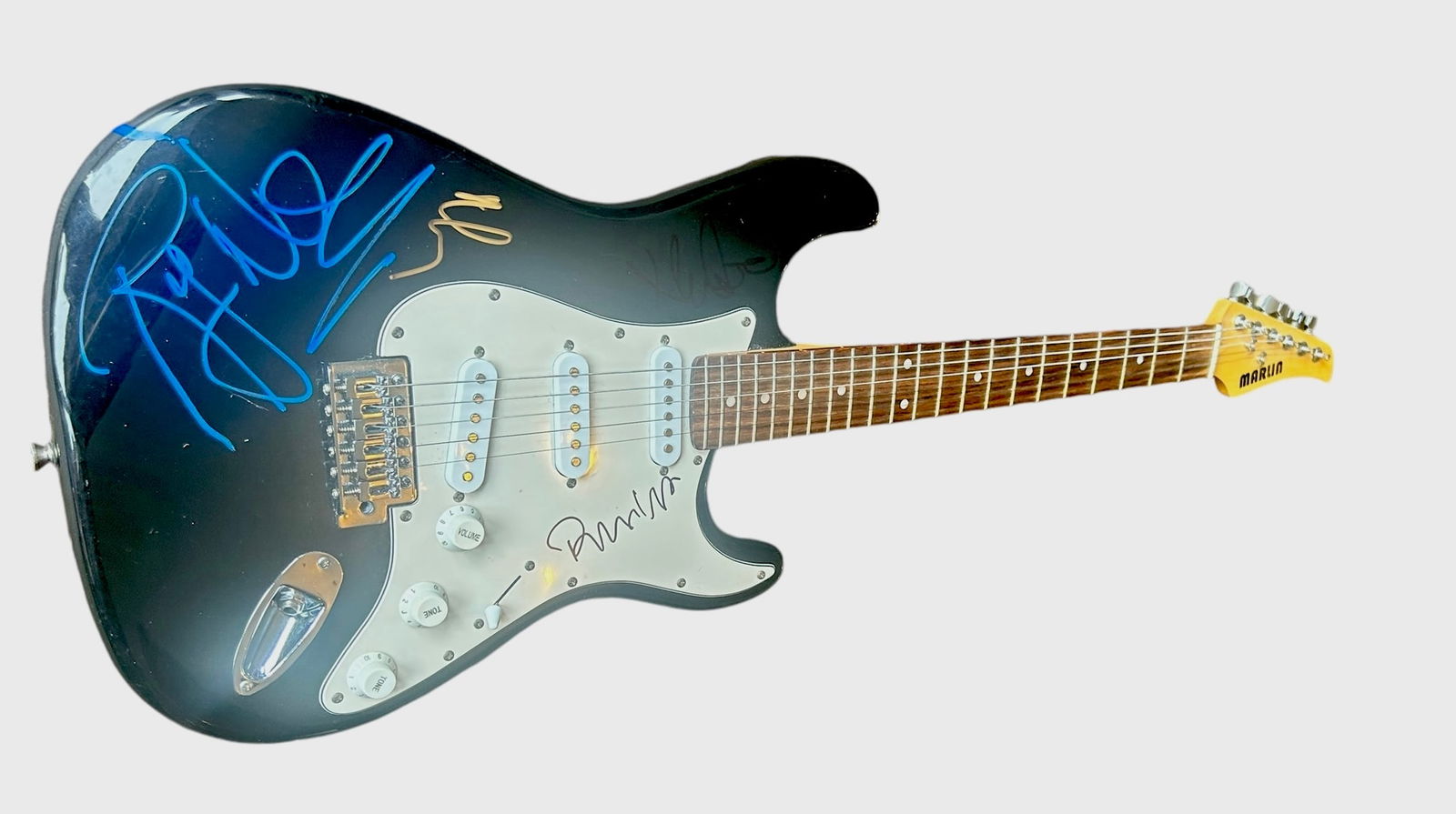 Pink Floyd Signed Electric Guitar: This lot is an electric guitar, autographed on the body in gold and black sharpie pen by Nick Mason, in blue sharpie pen by Roger Waters and on the pickguard in black sharpie pen by Richard Wright of