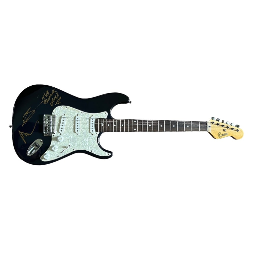The Black Keys Fully Signed Electric Guitar: This lot is an Encore electric guitar autographed by Dan Auerbach and Patrick Carney of The Black Keys. The guitar is signed on the body in gold sharpie pen. Item comes with third-party authentication