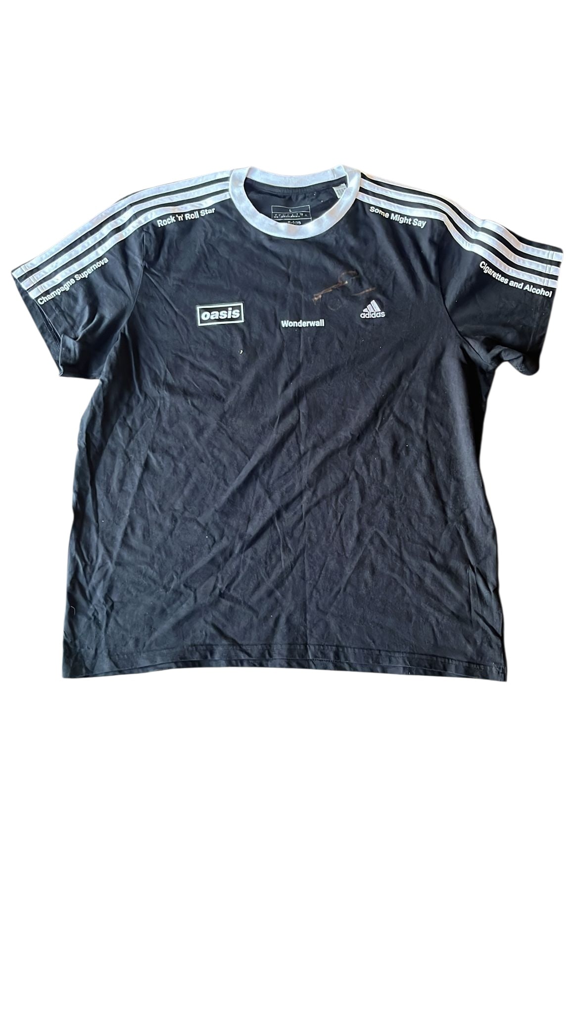 Oasis Noel Gallagher Signed T-Shirt: This lot is a t-shirt, autographed by Noel Gallgher of Oasis. Item comes with third-party authentication and affixed tamper-proof holographic QR sticker leading to item details and scoring.